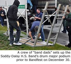 A crew of band dads sets up the Soddy-Daisy H.S. Band's drum major podium prior to Bandfest on December 30.