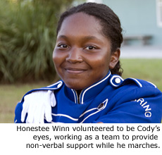 Honestee Winn volunteered to be Cody's eyes, working as a team to provide non-verbal support while he marches.