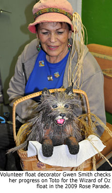 Volunteer float decorator Gwen Smith checks her progress on Toto for the Wizard of Oz float in the 2009 Rose Parade.